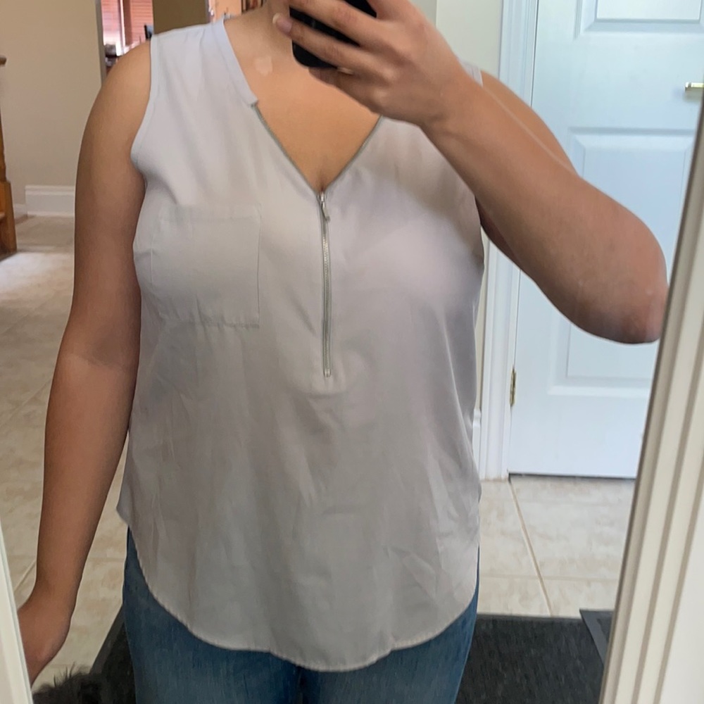 Flowy gray sleeveless blouse.